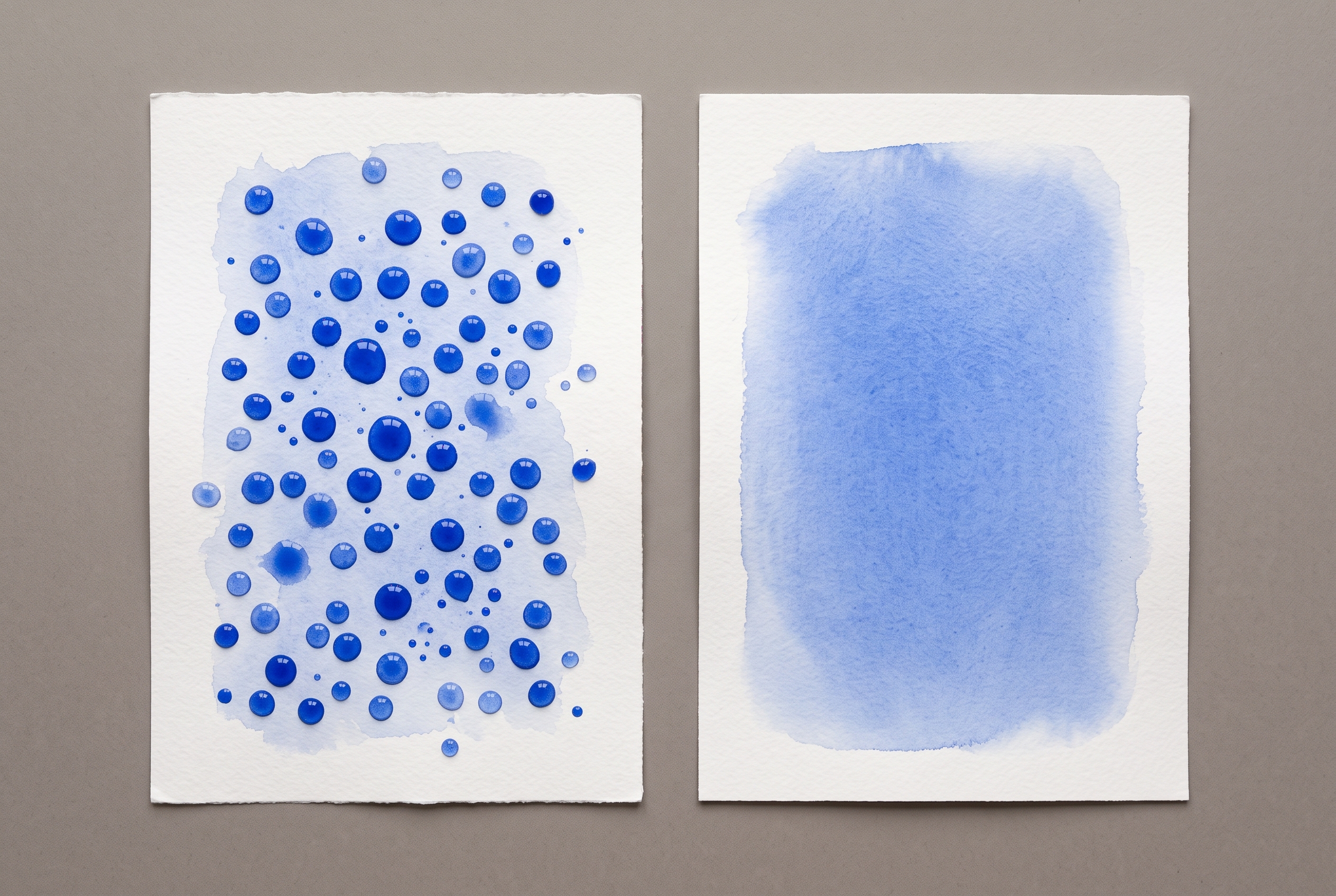 Two sheets of white watercolour paper with washes of the same transparent blue: on the left the wash has gathered into separate rounded beads; on the right it has spread into one even continuous field.
